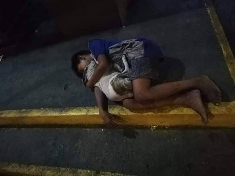 Niño sin hogar se aferra a su perrito para luchar contra el frío de la noche.